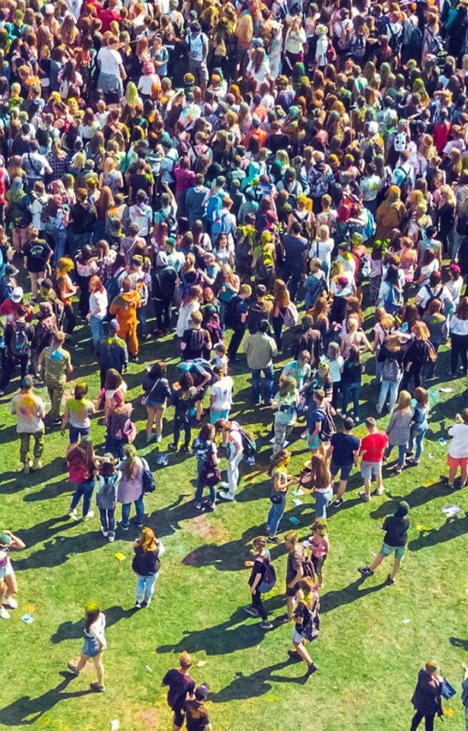 Large outdoor crowd enjoying a festival at Wvec West Valley Events Complex in Phoenix, Arizona, with people gathered on the lawn for a community event.