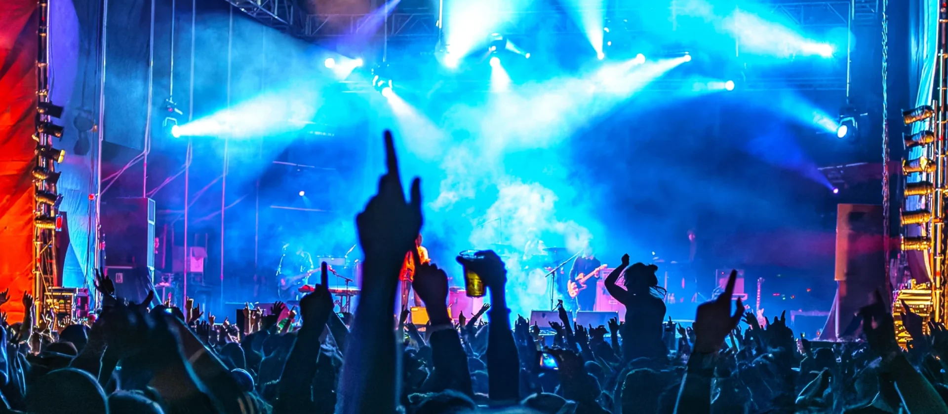 Nighttime outdoor music festival with live band and cheering crowd at Wvec West Valley Events Complex, Phoenix, Arizona.