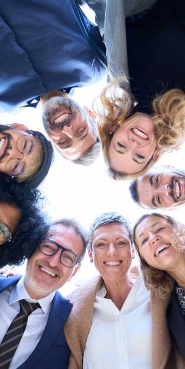 Happy group of diverse friends smiling in a circle at Wvec West Valley Events Complex in Phoenix, Arizona.